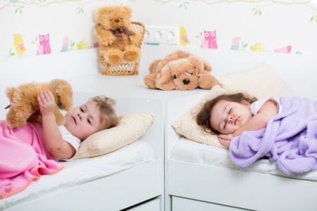 Little girls sleeping in their own beds