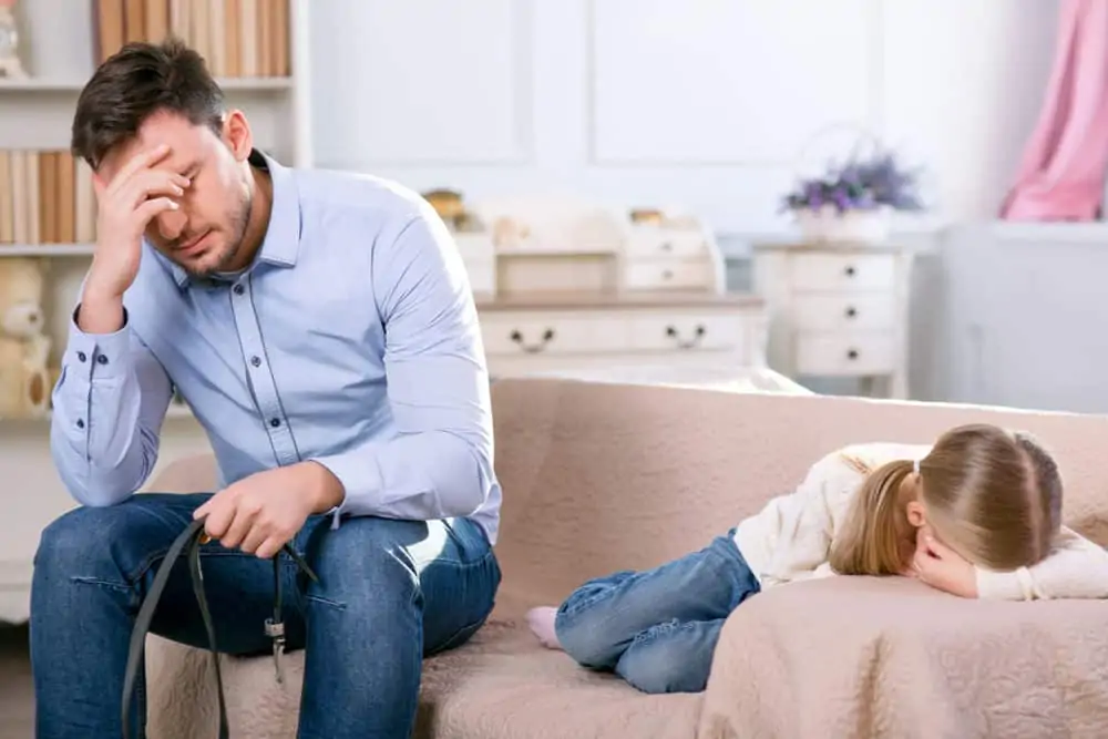Strict father punishing his daughter