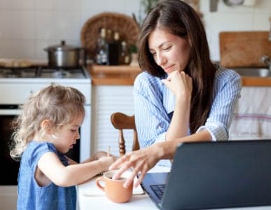 Mom working from home while playing with daughter