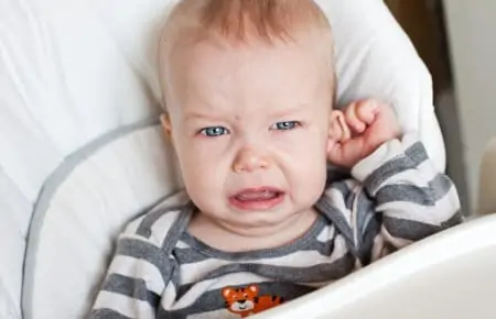 Cute little boy crying with ear infection