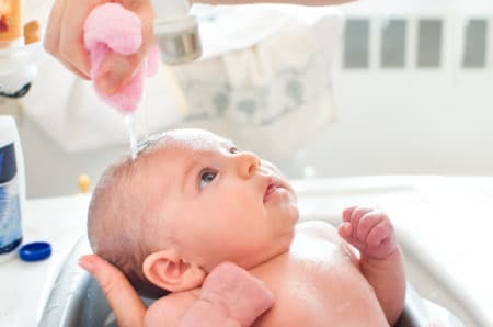 Bathing newborn with cradle cap