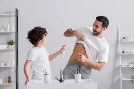 Boy spraying deodorant