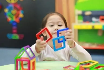 Little girl playing with magnetic toys