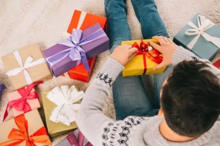 An 18-year-old boy opening gift boxes