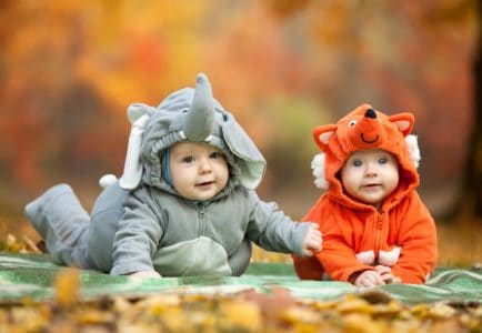 Two cute babies in Halloween costumes