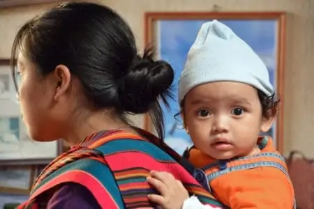 A mother carrying her adorable Native American baby girl