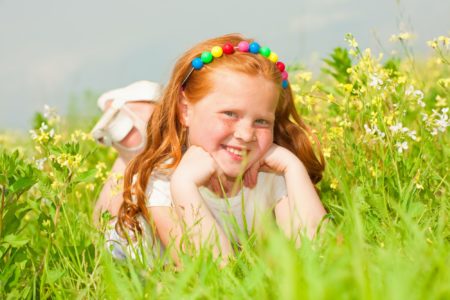 Happy and smiling Gaelic girl playing in the field
