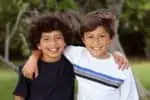 Two smiling Brazilian boys playing in the park