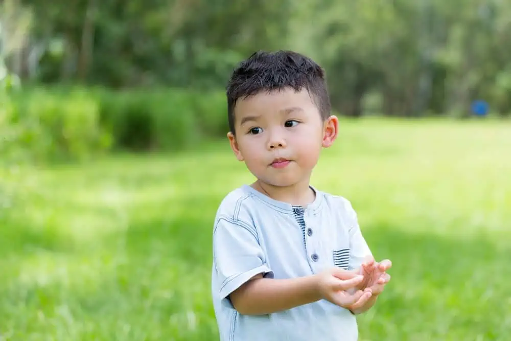 Little Vietnamese boy playing in the park