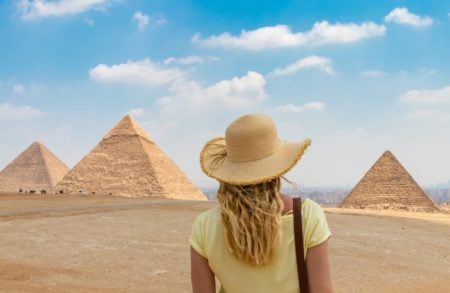 Girl looking at the Great Pyramid of Giza in Egypt