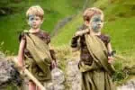 Two little boys dressed up as Celtic warriors playing outdoors