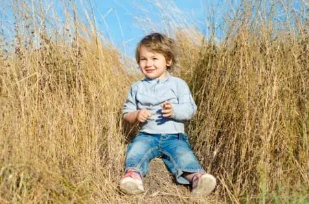 Smiling little boy on rural field