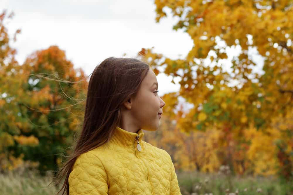 Beautiful brunette girl posing in autumn forest