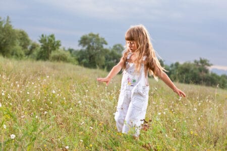Cute little girl on summer meadow
