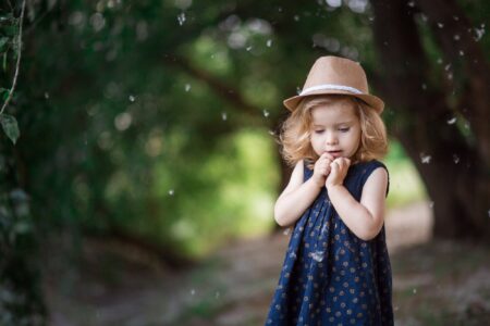 Little girl in a hat playing in the park