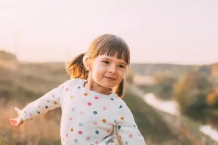 Cute little girl playing in the field