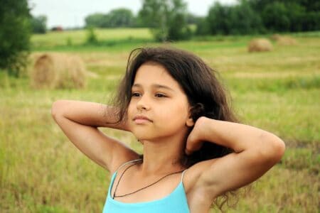 Beautiful young girl spending time in the field