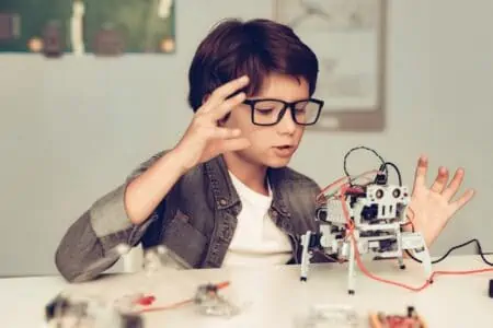 Boy constructing a robot