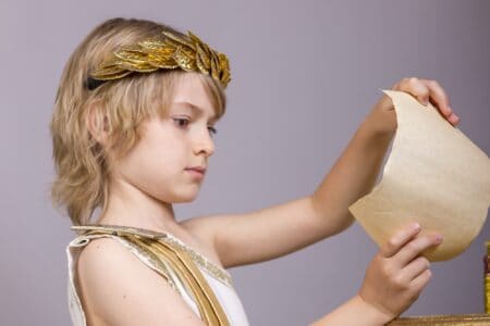Little Roman boy holding a papyrus scroll