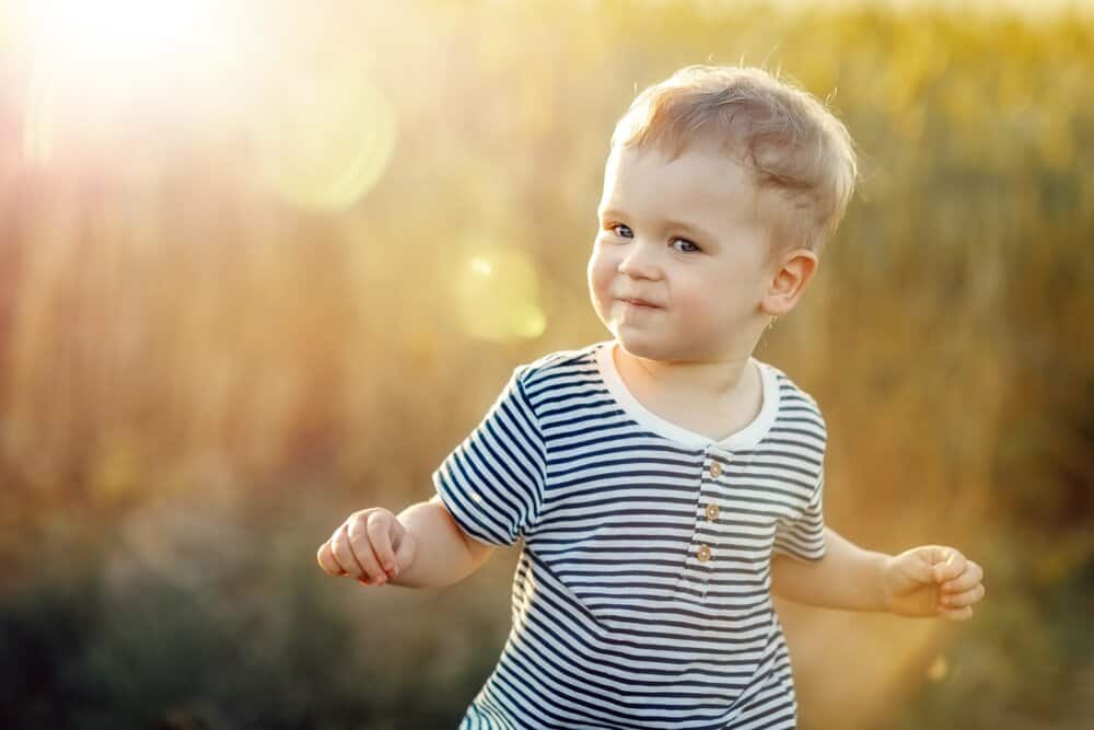 Smiling little boy playing in the field