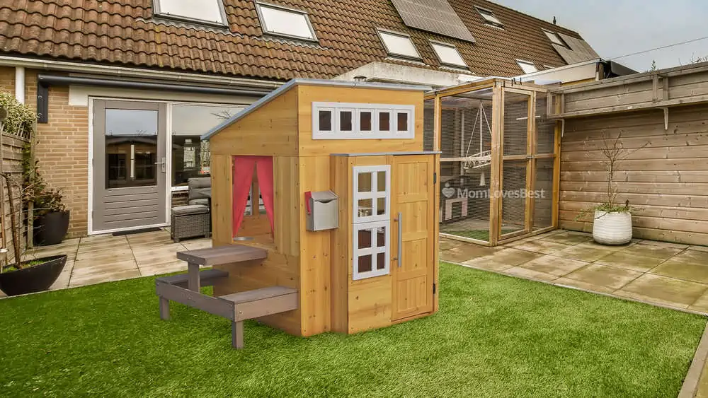 Photo of the KidKraft Modern Outdoor Wooden Playhouse with Picnic Table