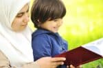 A Muslim mother reading a book to her son