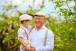 Happy grandpa holding his grandson
