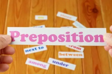 Hands holding a preposition card
