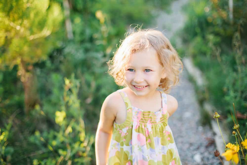 Happy little girl walking in the garden
