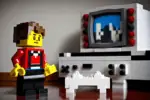 Lego character playing video games