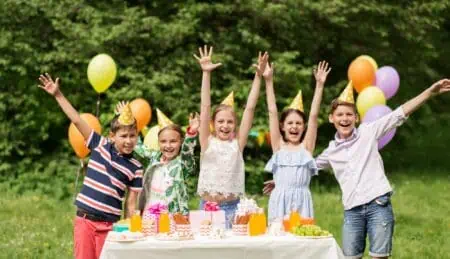 Happy kids on 14th birthday party at summer garden