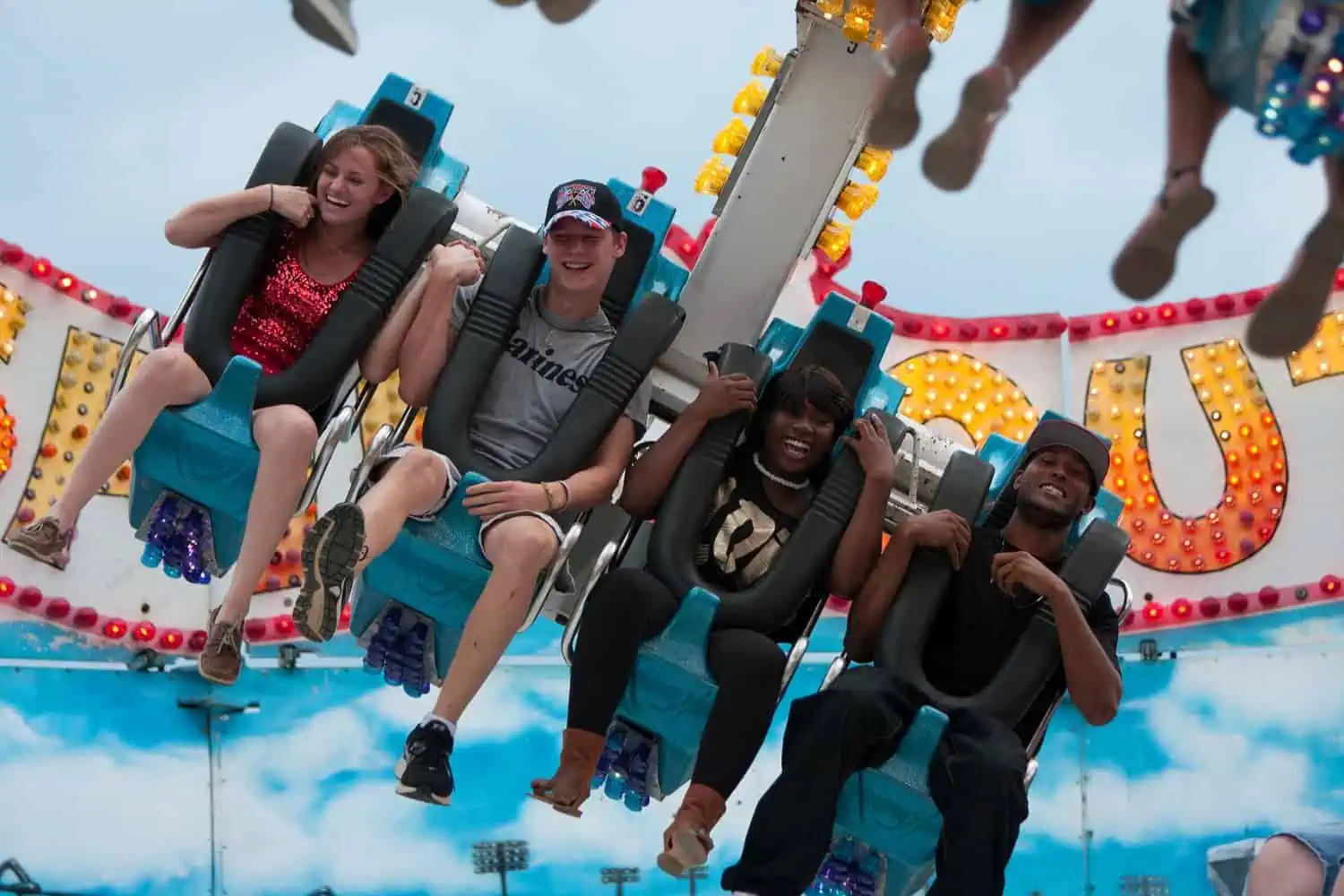 Happy teenagers enjoying rides at the amusement park