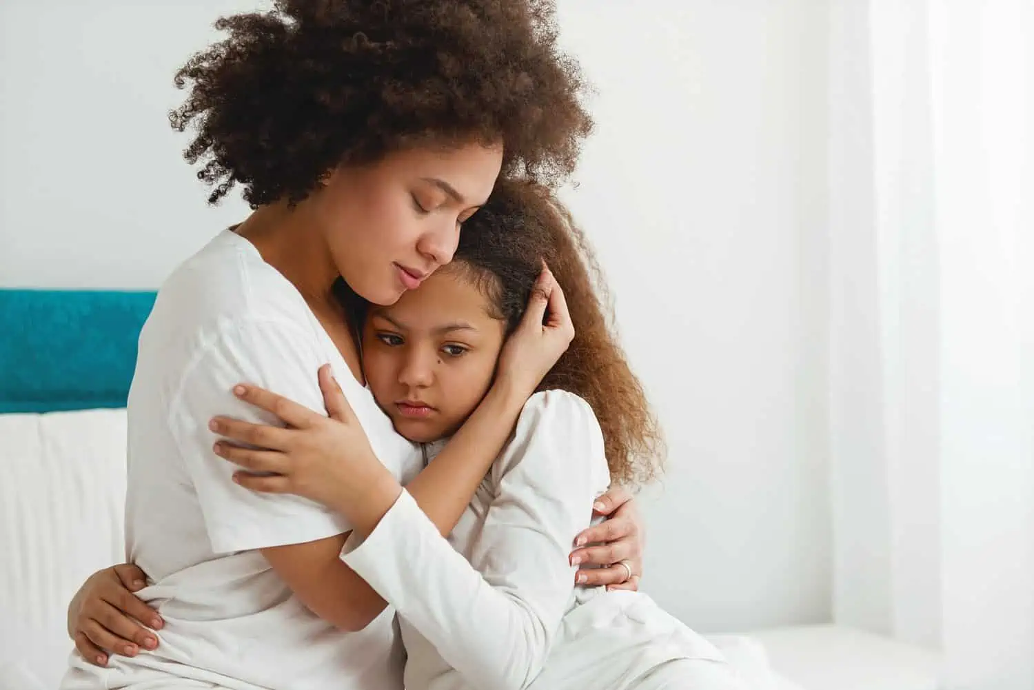 Mother hugging her distress daughter