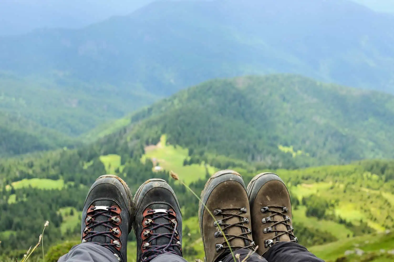 Hiking boots of traveler sitting on high mountain top