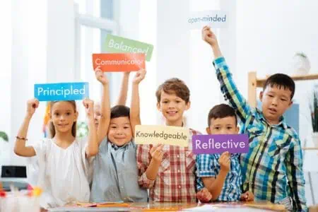 Cheerful children holding different colorful paper with written adjectives in their hands