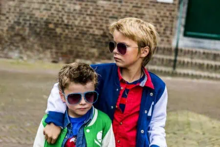 Two cool kids with sunglasses looking tough