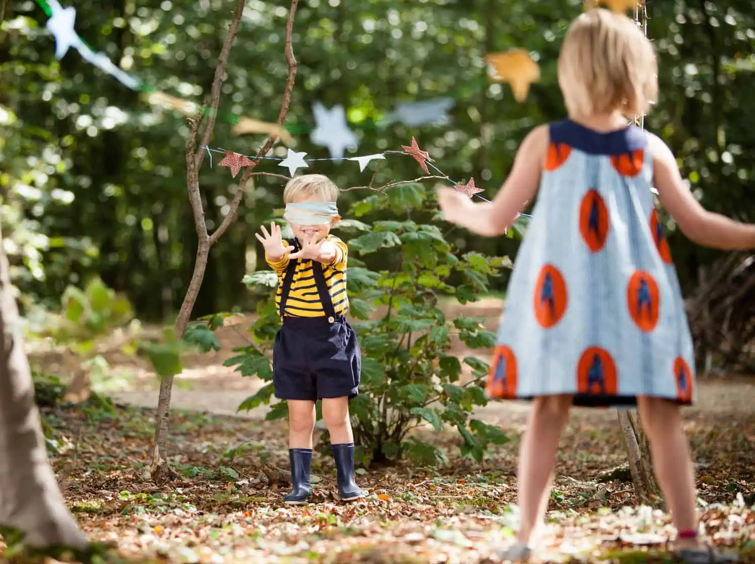 Blindfolded child playing hide and clap