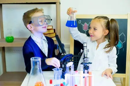 Kids making science experiments in laboratory