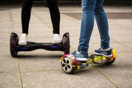 Two female legs on hoverboards