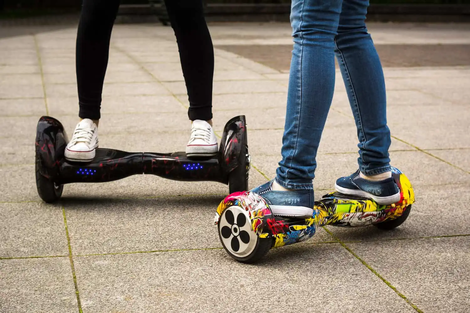 Two female legs on hoverboards