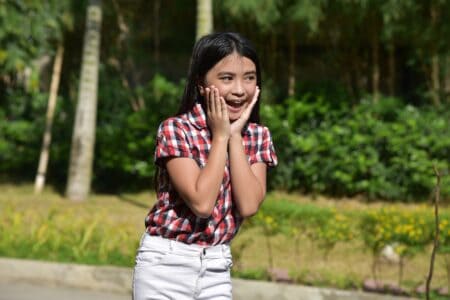 Filipino young girl smiling brightly outdoors