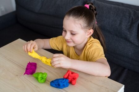 Young girl playing with homemade playdough