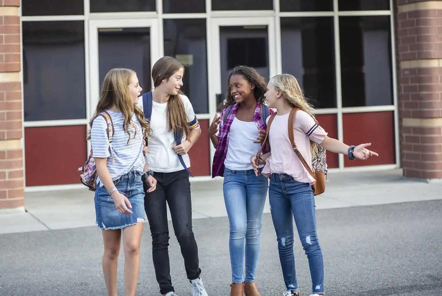 Middle school teen girls talking outside the school
