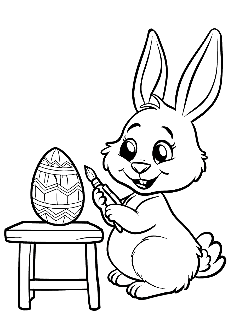 Easter Egg Painting Bunny Coloring Page - A bunny painting an Easter egg with a wide, happy smile, sitting at a small table.