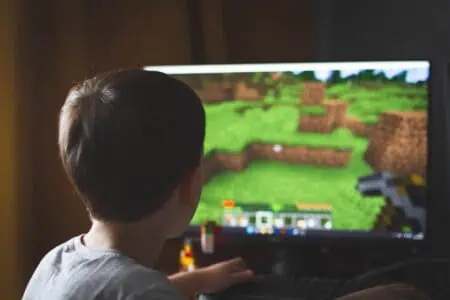 Little boy playing minecraft at home